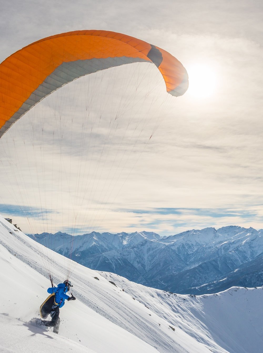 Paragliding over the snow-covered mountains of Salzburg  width=