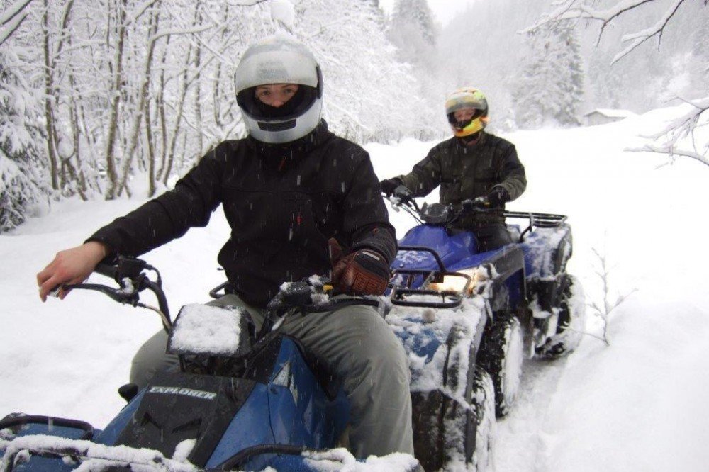 Quad biking with friends during the winter vacation in Saalbach